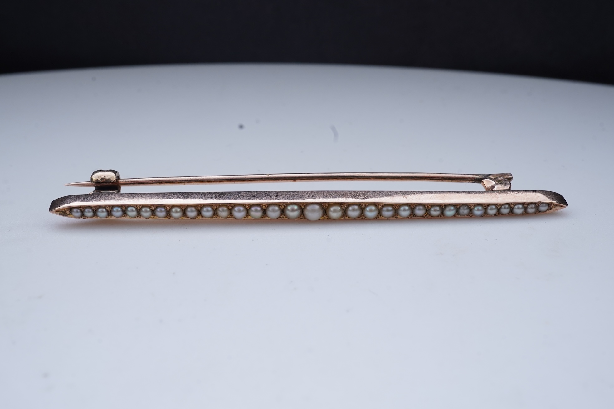 An Edwardian seed pearl brooch and a pearl and diamond ring